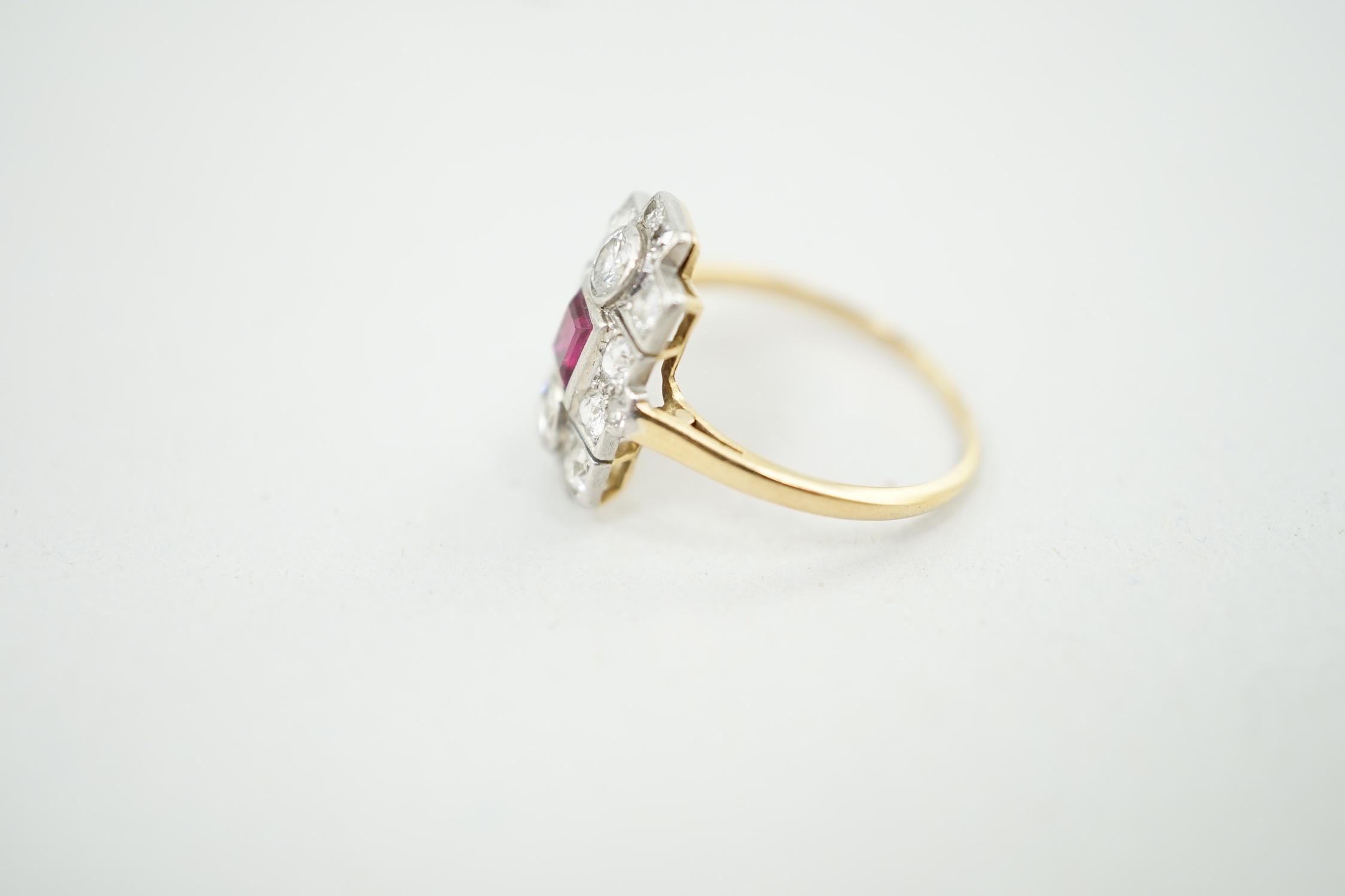 A 1920's gold and millegrain set ruby and diamond cluster dress ring